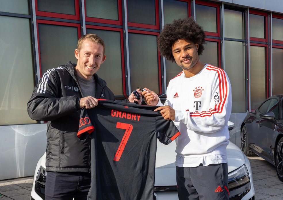 O craque Serge Gnabry posa com um funcionário da Audi após receber as chaves de seu RS e-tron GT — Foto: Divulgação